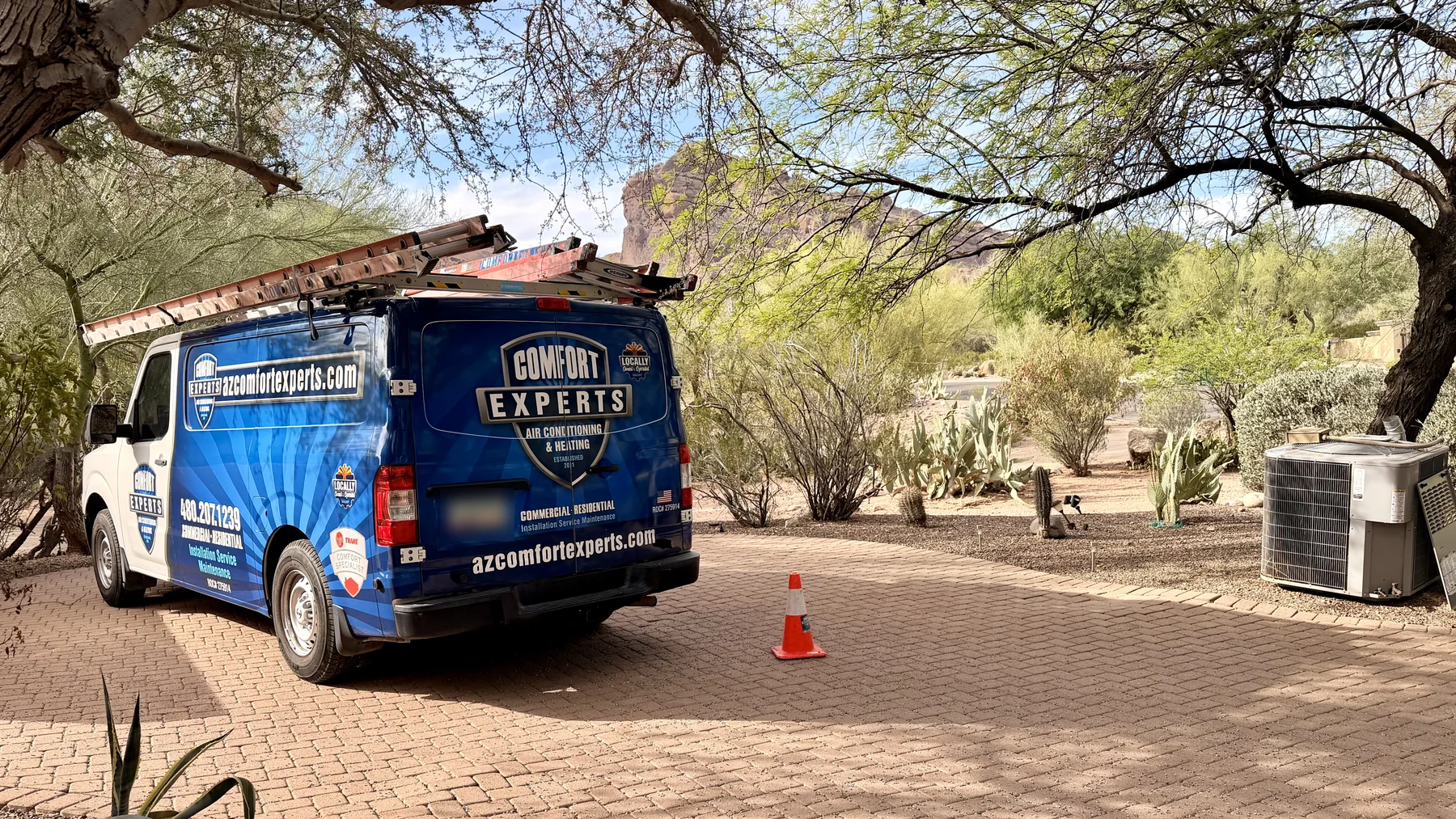 Comfort Experts service van beside a residential outdoor HVAC system